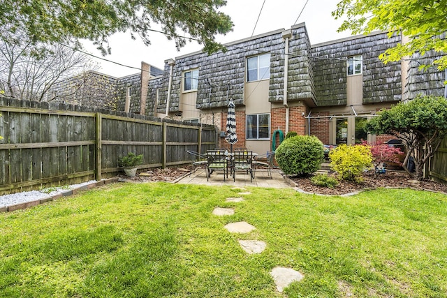 view of yard with a fenced backyard and a patio