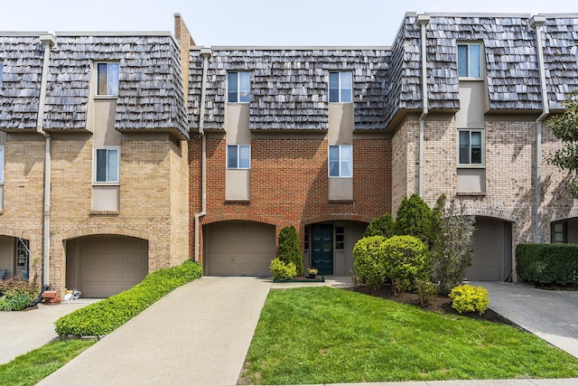 view of building exterior featuring an attached garage and driveway