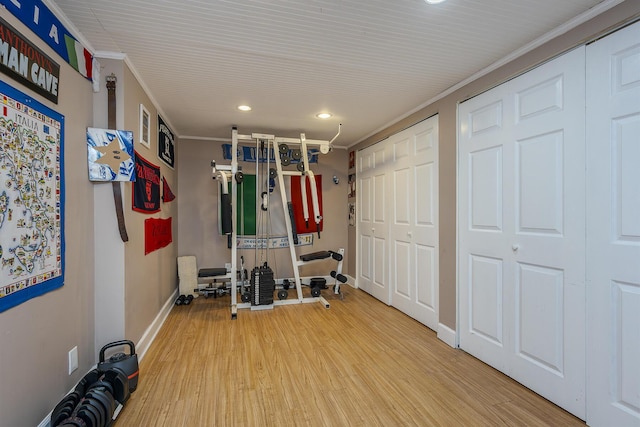 workout area with wood finished floors, baseboards, recessed lighting, and crown molding
