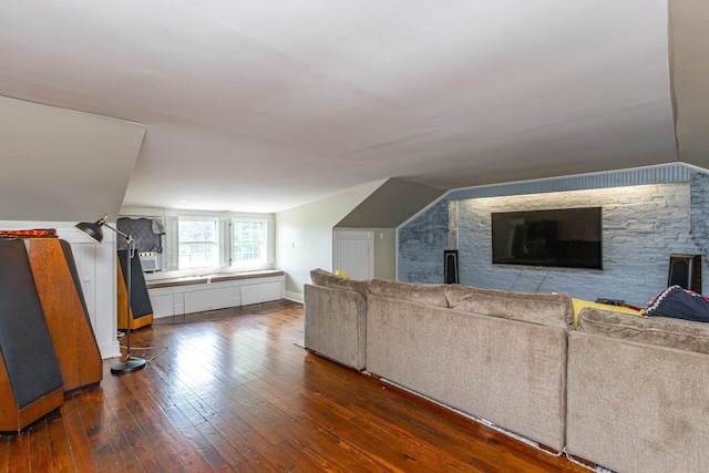additional living space with baseboards and hardwood / wood-style flooring