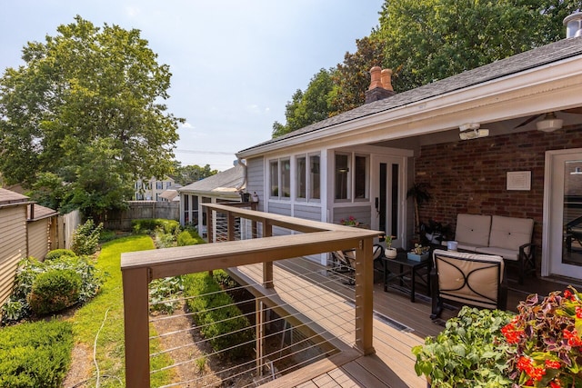 wooden terrace with fence and an outdoor hangout area