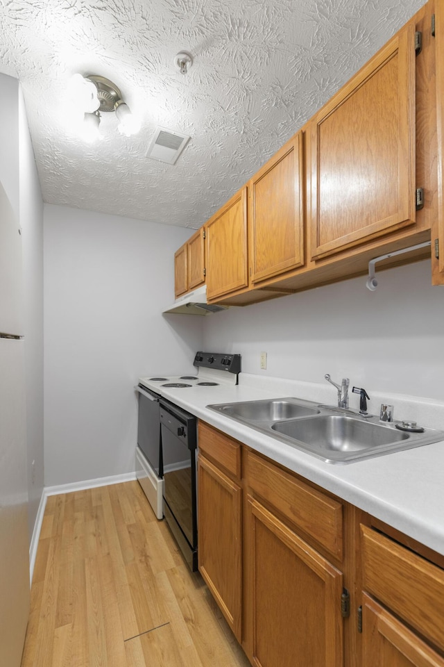 1081 S Broadway Unit 104, Lexington, KY 40504 - kitchen featuring light countertops, black dishwasher, light wood finished floors, and a sink