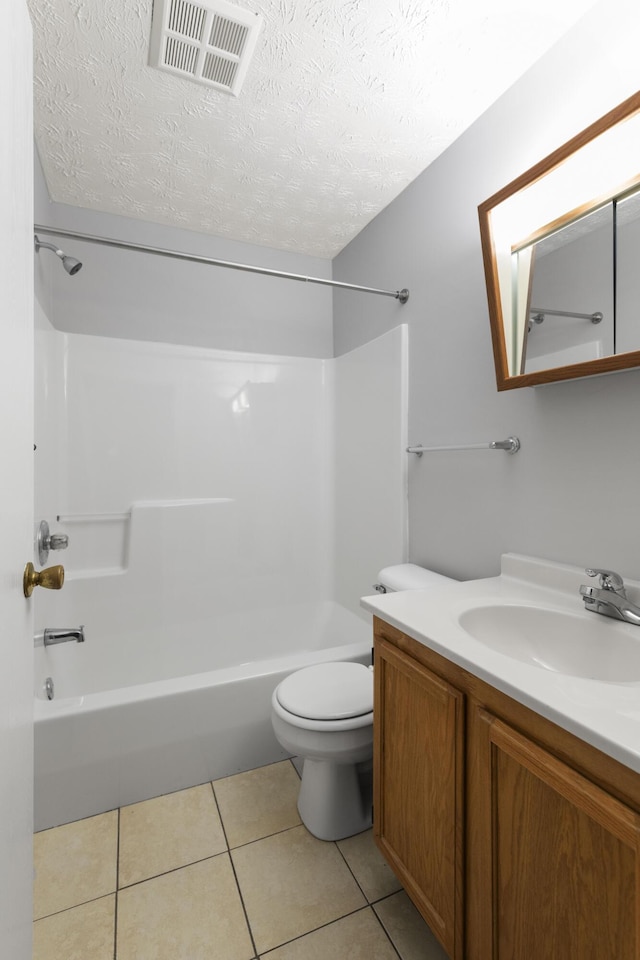 1081 S Broadway Unit 104, Lexington, KY 40504 - bathroom with a textured ceiling, toilet, visible vents, tile patterned flooring, and tub / shower combination