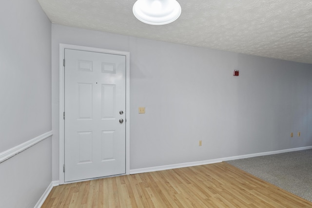 1081 S Broadway Unit 104, Lexington, KY 40504 - interior space featuring light wood-style flooring, baseboards, and a textured ceiling