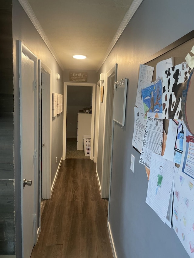 hall with baseboards, crown molding, and wood finished floors