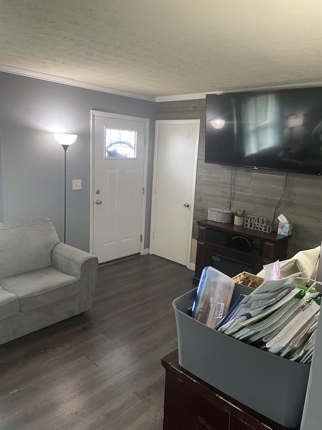 living area with wood finished floors and a textured ceiling
