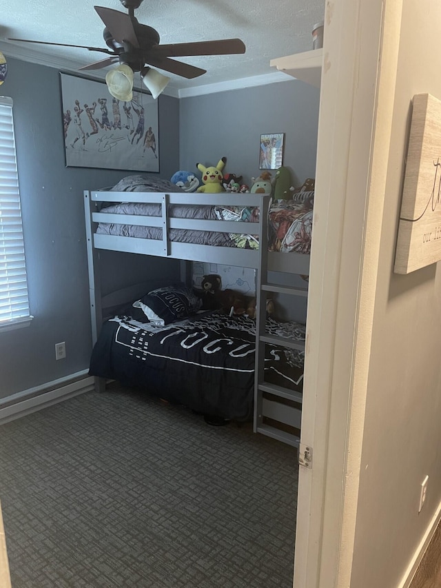 carpeted bedroom featuring a textured ceiling, ornamental molding, and ceiling fan