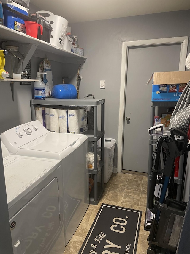 clothes washing area with washing machine and clothes dryer and laundry area