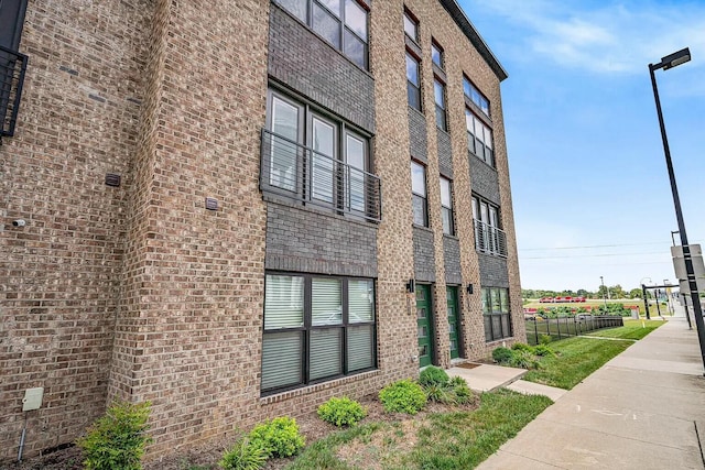 view of building exterior featuring fence