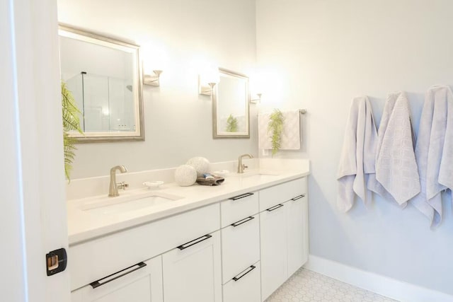 bathroom with a sink, baseboards, and double vanity