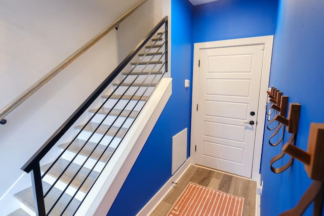 interior space featuring baseboards, visible vents, and wood finished floors
