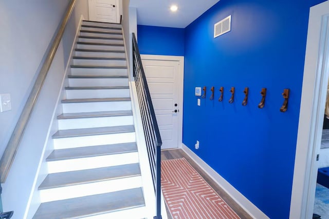 staircase with baseboards and visible vents