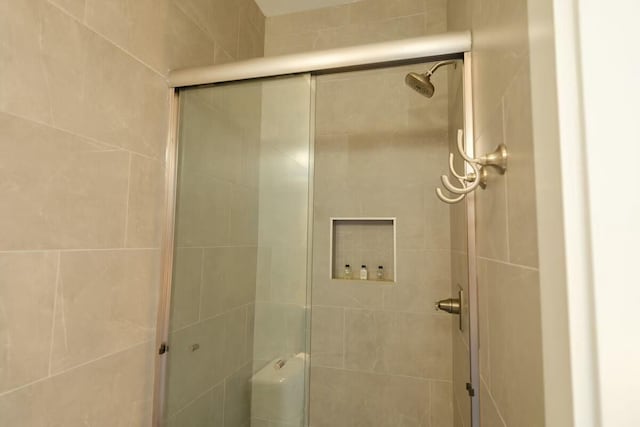 full bath with a shower stall