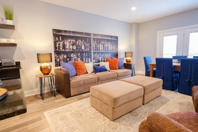 living area featuring recessed lighting, baseboards, and wood finished floors