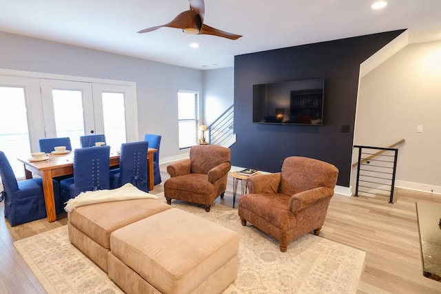 living room with light wood-type flooring, recessed lighting, baseboards, and a ceiling fan