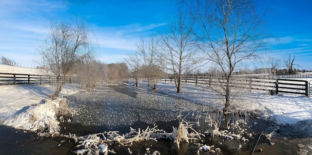 yard covered in snow with fence
