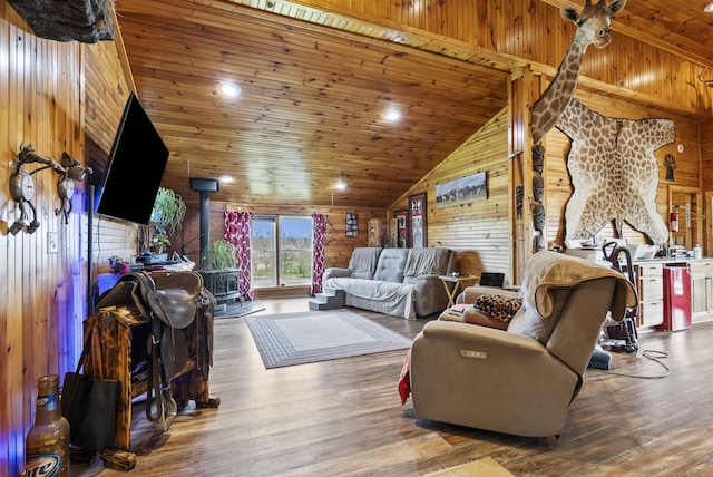 living room with a wood stove, wood walls, recessed lighting, wooden ceiling, and wood finished floors