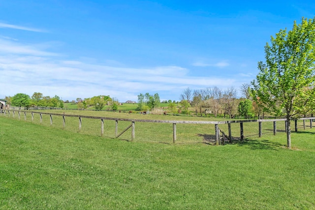 view of yard featuring fence and a rural view