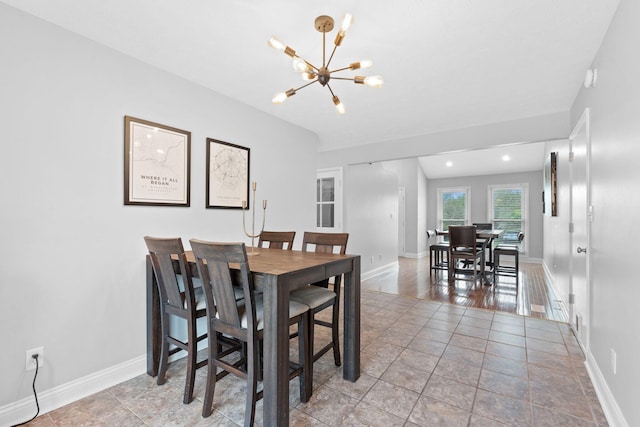 dining room featuring baseboards and a chandelier