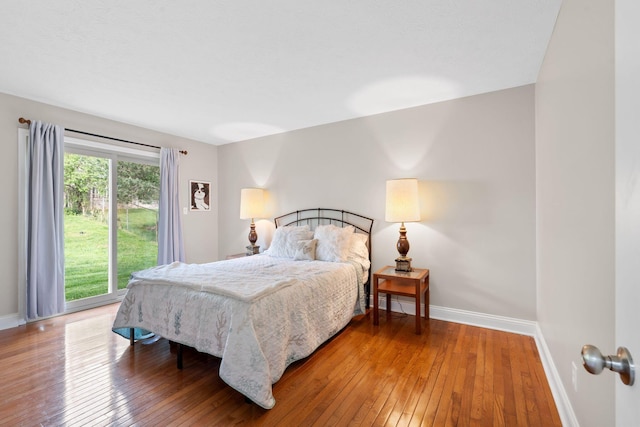 bedroom featuring baseboards and wood-type flooring