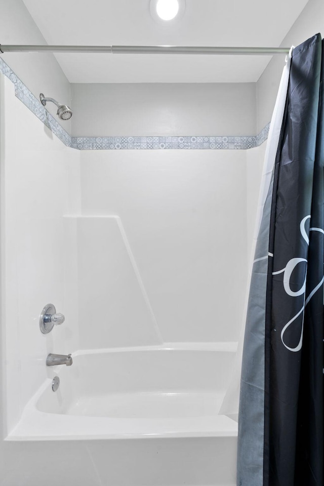 full bathroom with shower / tub combo with curtain