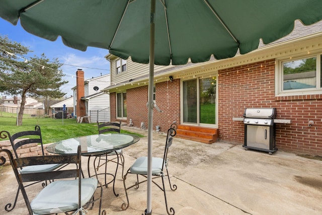 view of patio / terrace with area for grilling, fence, outdoor dining space, and entry steps