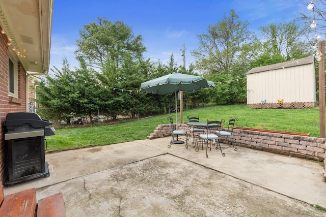 view of patio / terrace featuring an outdoor structure, outdoor dining area, and a grill