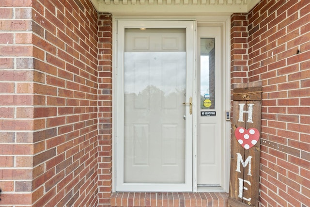 property entrance with brick siding