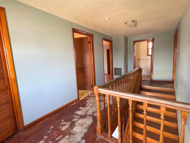 1312 Roosevelt St, Corbin, KY 40701 - corridor with a textured ceiling, visible vents, baseboards, and carpet
