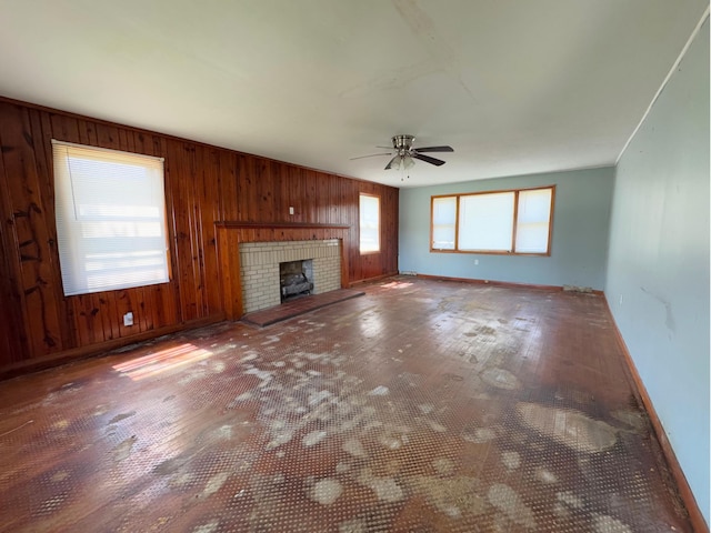 1312 Roosevelt St, Corbin, KY 40701 - unfurnished living room featuring wood finished floors, a fireplace, baseboards, ceiling fan, and wooden walls