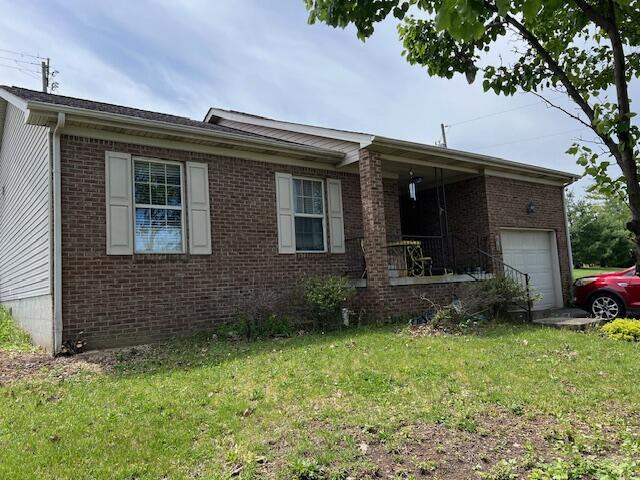 130 Fox Harbor Dr, Danville, KY 40422 - ranch-style house featuring brick siding, a front lawn, an attached garage, and covered porch