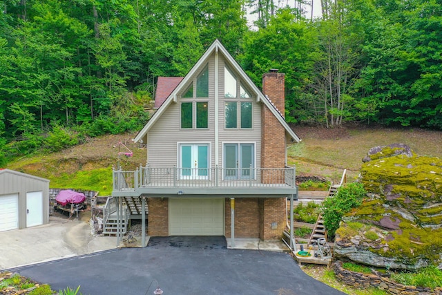 832 Cliffs Edge Rd, East Bernstadt, KY 40729 - chalet / cabin featuring stairway, a chimney, driveway, french doors, and brick siding