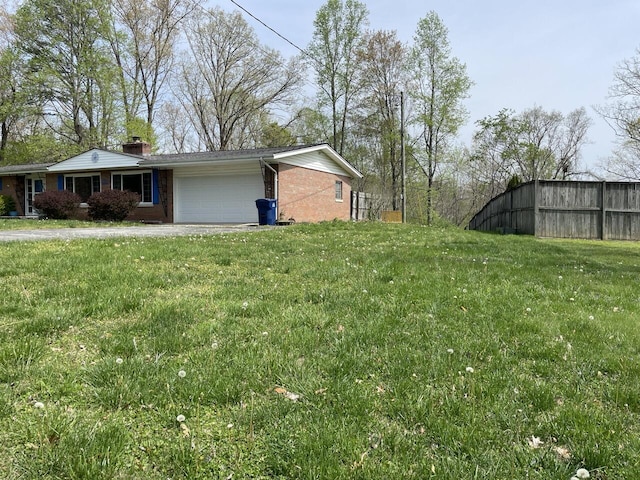 view of yard featuring fence and a garage