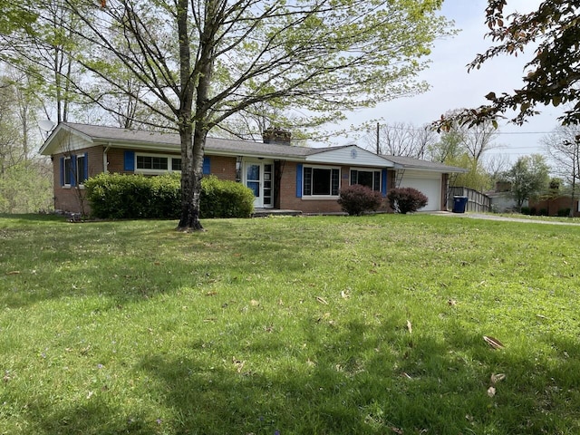ranch-style house with a chimney, a front lawn, brick siding, and a garage