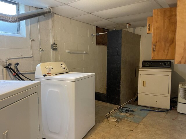 washroom featuring separate washer and dryer and cabinet space