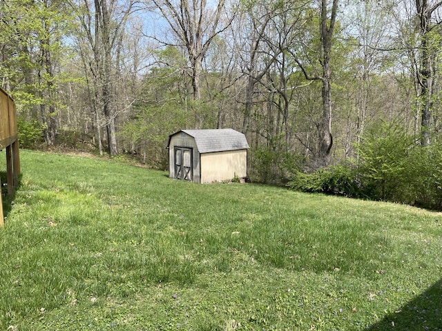 view of yard featuring a storage shed and an outbuilding
