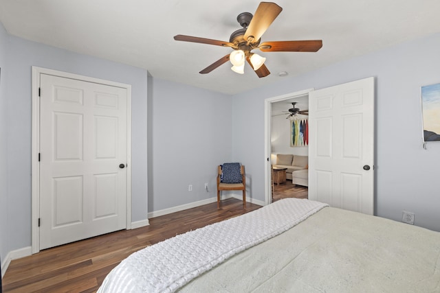 bedroom with baseboards, wood finished floors, and ceiling fan