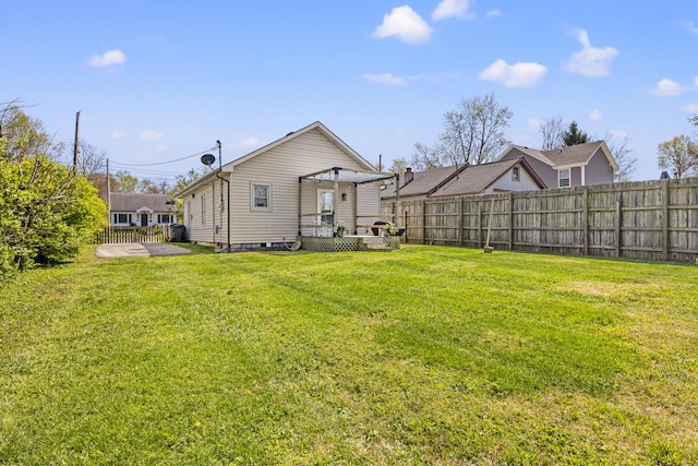 view of yard with fence and a wooden deck
