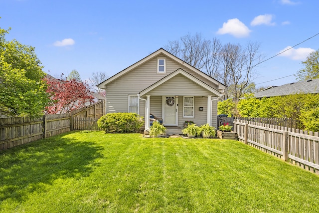 view of front of home featuring a fenced backyard, covered porch, and a front yard
