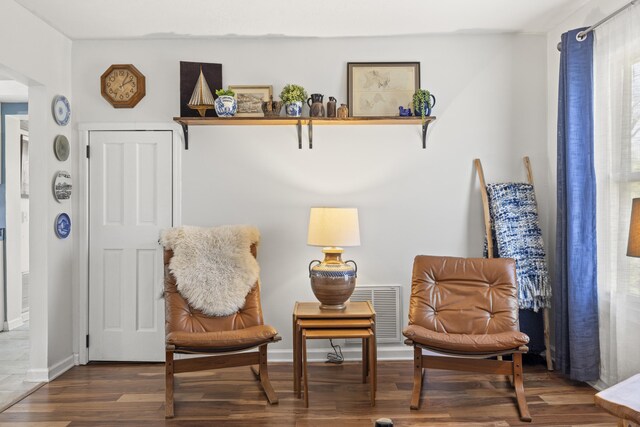 sitting room featuring baseboards and wood finished floors