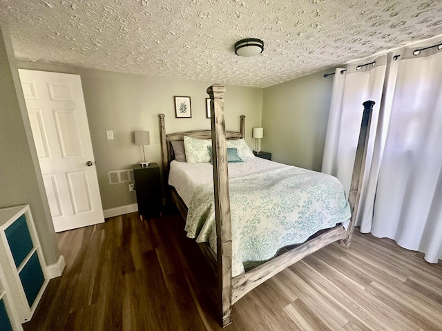 641 Webster Spradlin Rd, Monticello, KY 42633 - bedroom with visible vents, baseboards, wood finished floors, and a textured ceiling