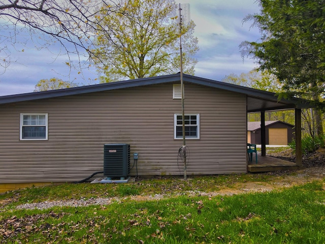 641 Webster Spradlin Rd, Monticello, KY 42633 - view of property exterior featuring central AC, a wooden deck, and an outbuilding
