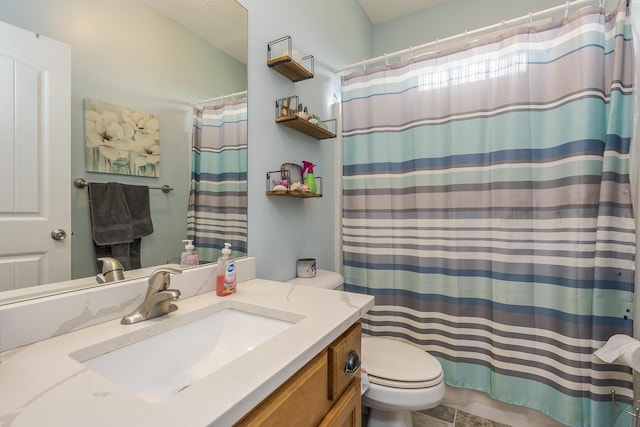 bathroom featuring vanity, toilet, and curtained shower