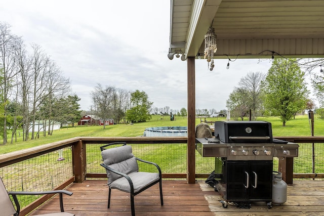 deck with a lawn and area for grilling