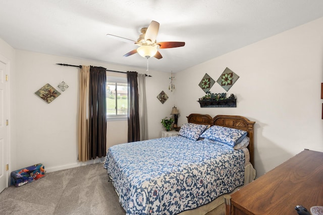 carpeted bedroom featuring baseboards and a ceiling fan
