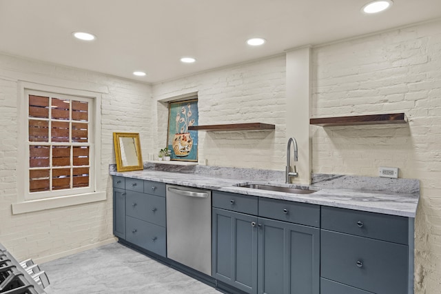 kitchen with stainless steel dishwasher, a sink, recessed lighting, brick wall, and light stone counters