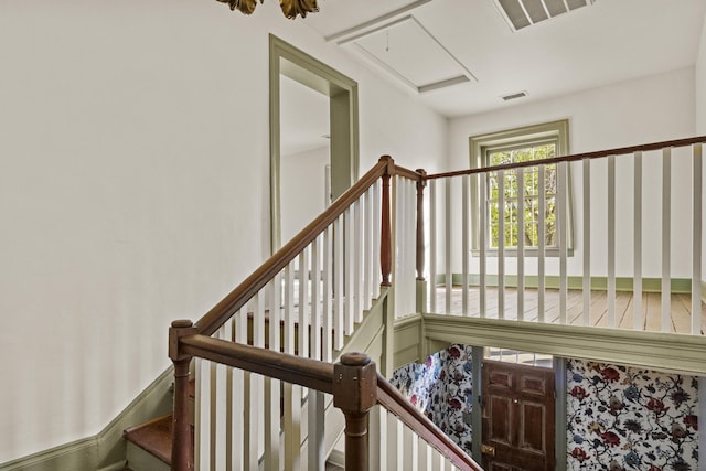 staircase with attic access and visible vents