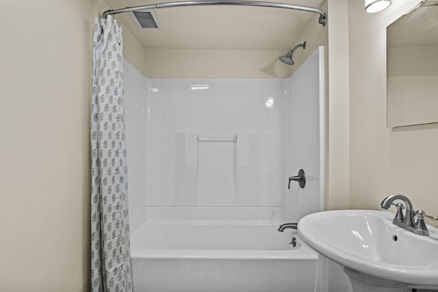 full bath featuring a sink, visible vents, and shower / bathtub combination with curtain