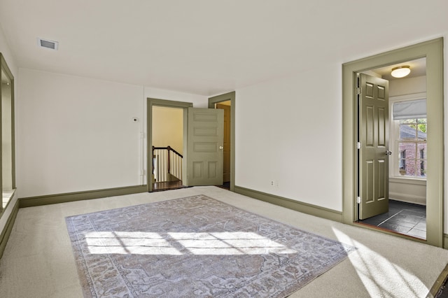 carpeted bedroom with visible vents and baseboards