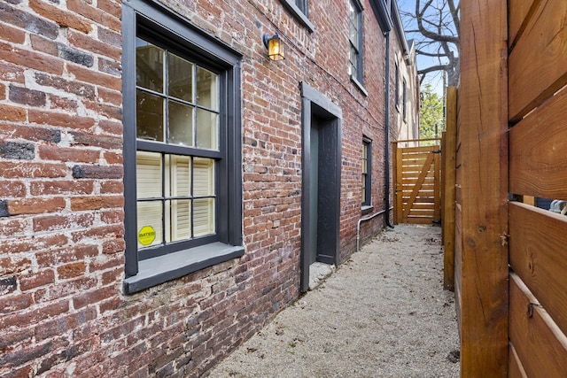 view of side of home featuring brick siding